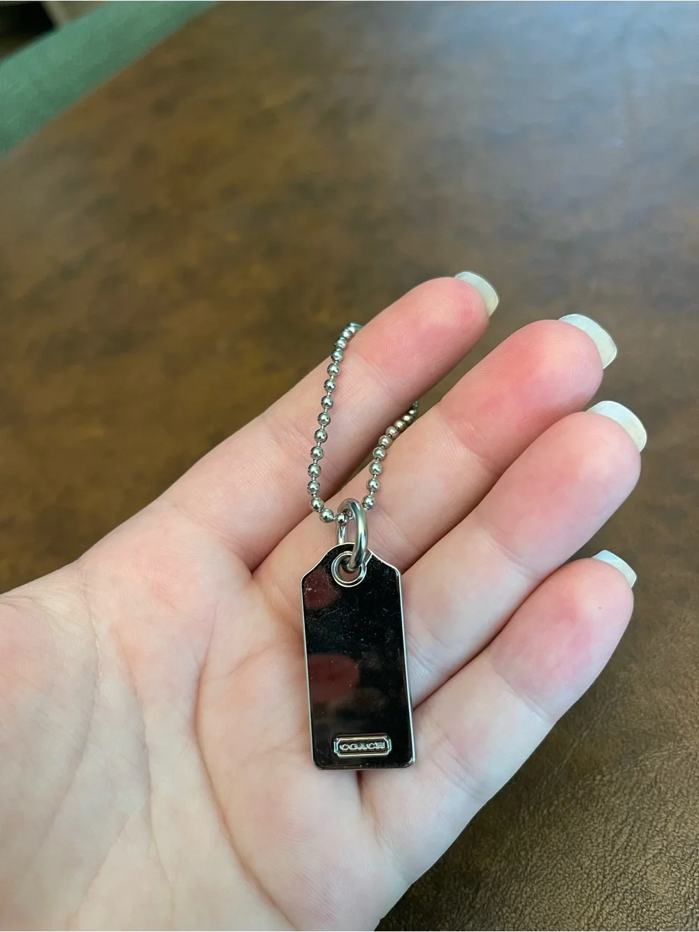 Coach silver metal hangtag